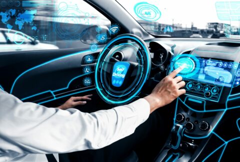Self-drive autonomous car with man at driver seat.
